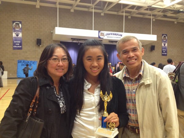 Melanie and family are happy as she trophies in her first tournament.